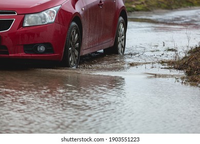 Car stuck in the mud, car wheel in a dirty puddle, rough terrain - Shutterstock ID 1903551223