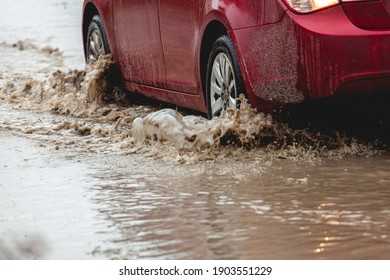 Car stuck in the mud, car wheel in a dirty puddle, rough terrain - Shutterstock ID 1903551229