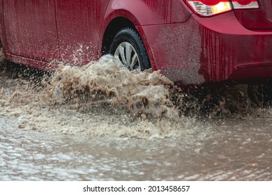 Car Stuck In The Mud, Car Wheel In A Dirty Puddle, Rough Terrain. Blur Motion