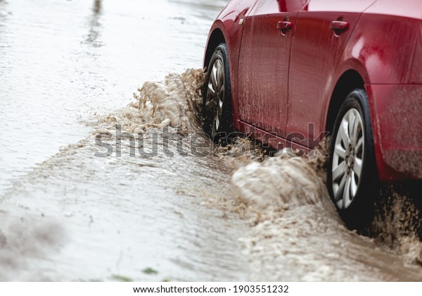Car stuck in the mud, car wheel in a dirty
puddle, rough terrain