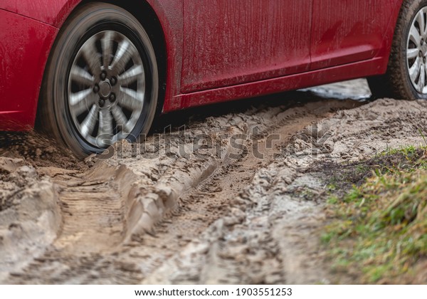 Car stuck in the mud, car wheel in a dirty\
puddle, rough terrain