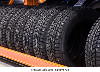 Car Studded Tires In A Row On A Shelf 