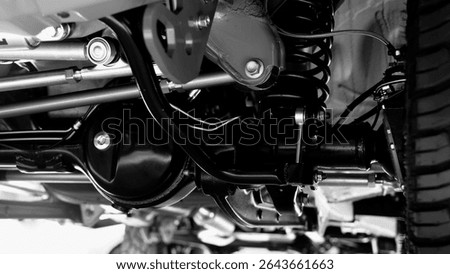 Car suspension part. Close up of a rear car suspension and exhaust system. such as coil springs link arms axle housing and performance exhaust. For auto engineering or car suspension part industry use
