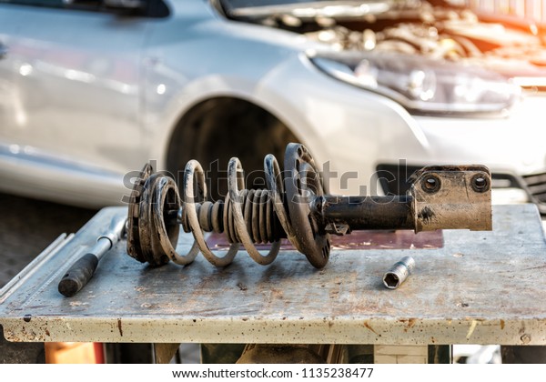 Car suspension repair.\
Shock absorber.