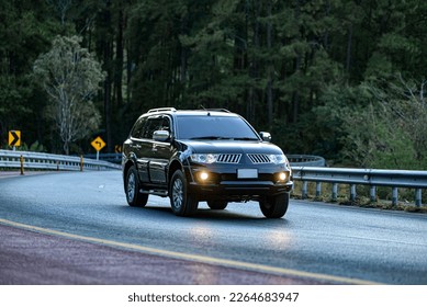 car suv on the road rides away. Travel on vacation, enjoy the nature trail	