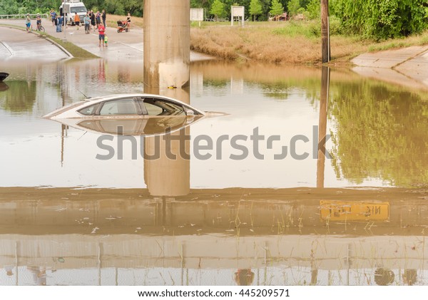 Car swamped by flood water near Buffalo Bayou\
Park in Houston, Texas. Flooded car under deep water on a heavy\
high water road. Disaster Motor Vehicle Insurance Claim Themed.\
Severe weather concept.
