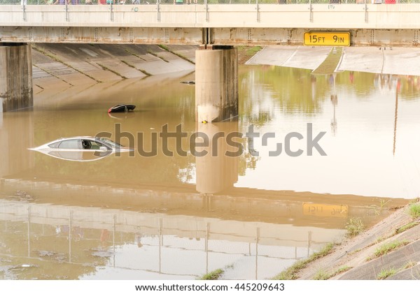 Car swamped by flood water near Buffalo Bayou
Park in Houston, Texas. Flooded car under deep water on a heavy
high water road. Disaster Motor Vehicle Insurance Claim Themed.
Severe weather concept.