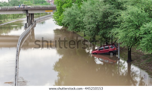 Car swamped by flood water near Buffalo Bayou
Park in Houston, Texas. Flooded car under deep water on a heavy
high water road. Disaster Motor Vehicle Insurance Claim Themed.
Severe weather, panorama.