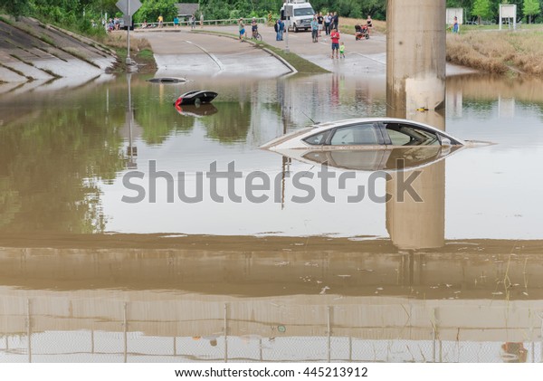 Car swamped by flood water near Buffalo Bayou\
Park in Houston, Texas. Flooded car under deep water on a heavy\
high water road. Disaster Motor Vehicle Insurance Claim Themed.\
Severe weather concept.