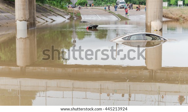 Car swamped by flood water near Buffalo Bayou\
Park in Houston, Texas. Flooded car under deep water on a heavy\
high water road. Disaster Motor Vehicle Insurance Claim Themed.\
Severe weather, panorama.