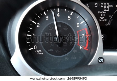 Car tachometer. Close up shot of a tachometer in a car. At an engine speed of 3500 rpm on Car dashboard. Close up of car dashboard. Vehicle instrument panel with tachometer. 