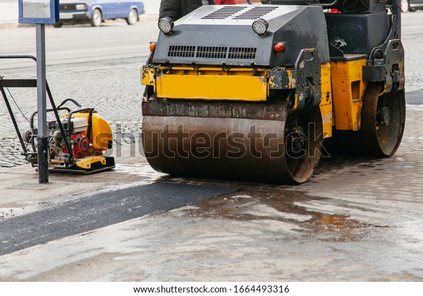 car tamps\
asphalt on the sidewalk in the\
city