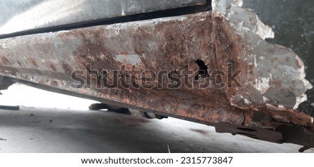 Car technician removes old paint from car roof with hand scraping old paint. Remover old paint. Rust caused on car Deterioration of car paint that causes corrosion and Rust on the body of the ca