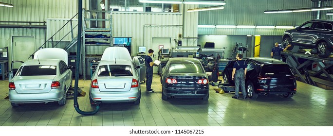 Car Technician Repairing Car In Workshop Service Station 