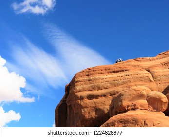 A Car Teetering On The Brink Of Disaster On A Dome In Moab, Utah