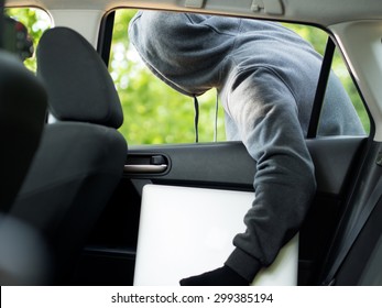 Car Theft - A Laptop Being Stolen Through The Window Of An Unoccupied Car.  