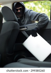 Car Theft - A Laptop Being Stolen Through The Window Of An Unoccupied Car.  