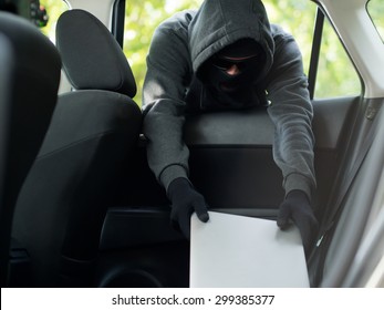 Car Theft - A Laptop Being Stolen Through The Window Of An Unoccupied Car.  