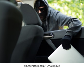 Car Theft - A Laptop Being Stolen Through The Window Of An Unoccupied Car.  