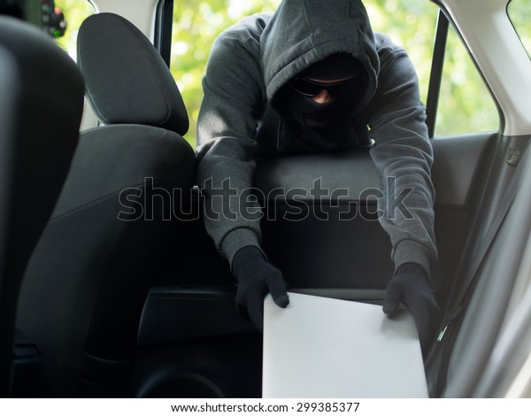 Car theft - a laptop being stolen through the\
window of an unoccupied car. \
