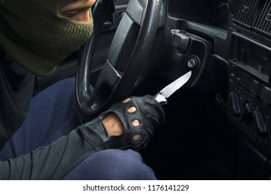 Car Theft In Mask And Black Gloves Breaking Down The Car Lock. Carjacking Concept