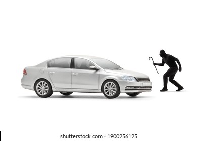 Car thief in black clothes and balaclava walking towards a silver car isolated on white background
