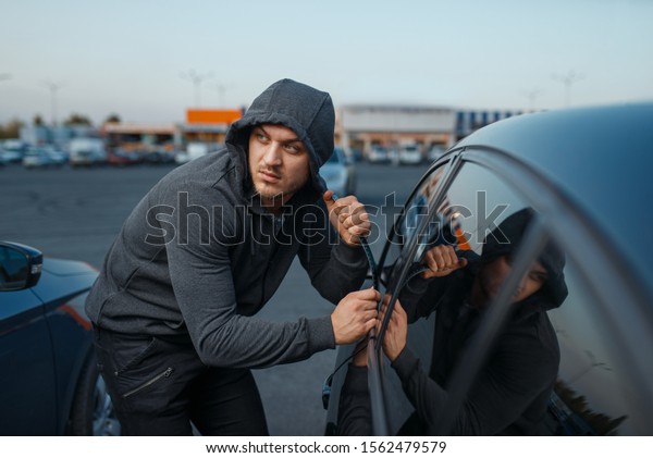 Car thief breaking\
door lock, criminal job