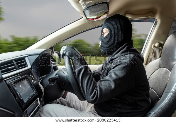 Car\
thief man runaway with a stolen car on the\
street