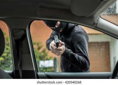  A Car Thief Pointing A Gun At The Driver - Car Owner