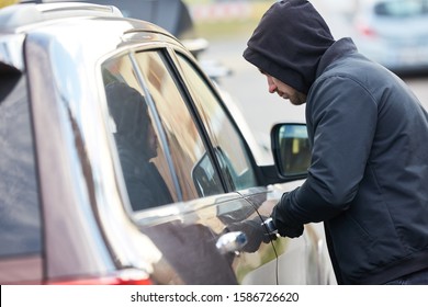 Car Thief Stealing A Car At The Car Door