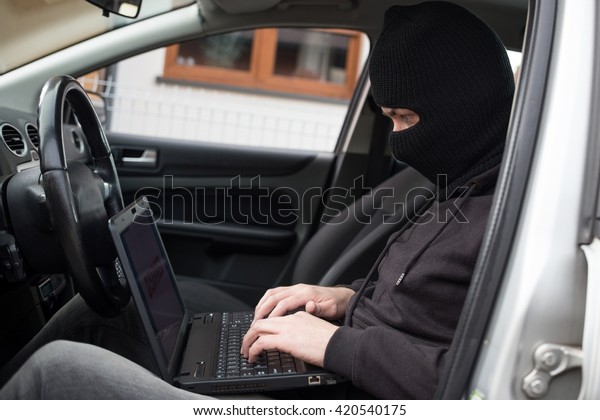 Car Thief tries to\
disarm car security systems and immobiliser with laptop computer.\
Car thief, car theft