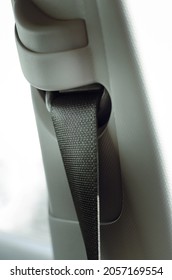 car three-point safety belt, the concept of road safety, life and health of the driver and passengers, compliance with traffic rules. Automobile salon interior, close-up.