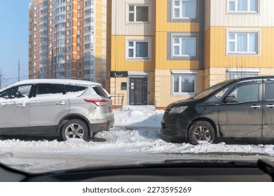 From the car through the windshield view of the two cars standing.