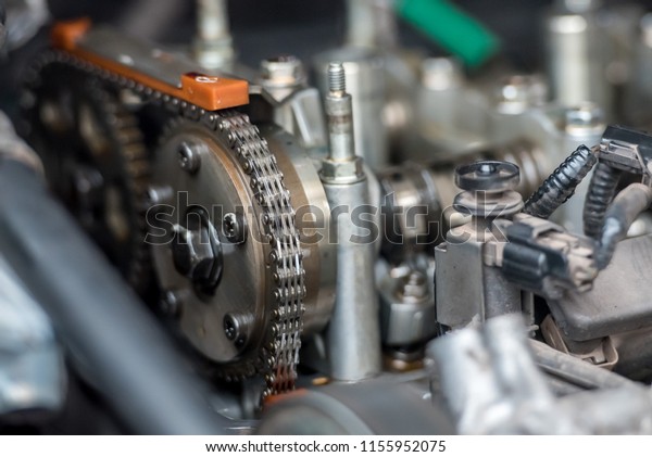 Car timing chain in\
cutaway engine
