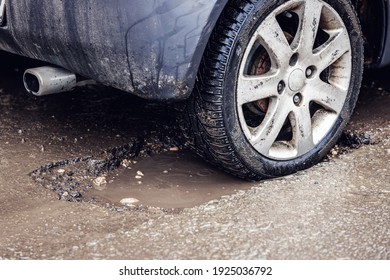 Car Tire In Big Pothole On The Road