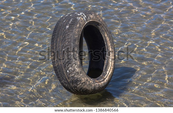Car tire in the clear waters of the Ohrid\
Lake, Struga, Northern\
Macedonia.