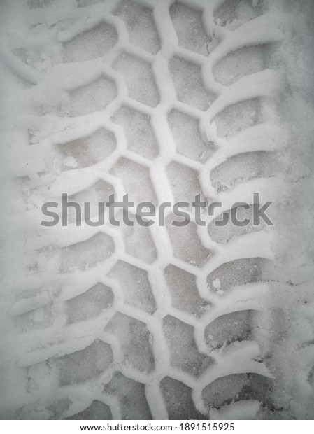 Car tire marks over the\
snow