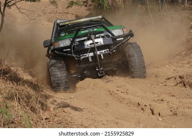 Car Tire Mud Terrain Green Pickup Off Road  4WD 4x4 Spin Mud Dirty Track On Mountain Hill.                                  