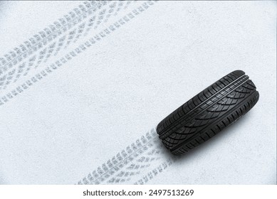 Car tire on winter road covered with snow