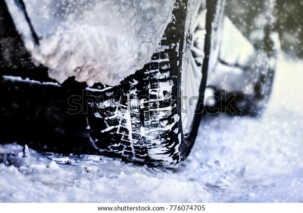 Car tire on winter road, Tires on snow, Close up\
of  car tire in winter