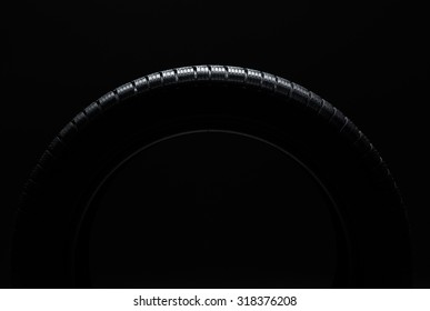 Car Tire Over Black Background