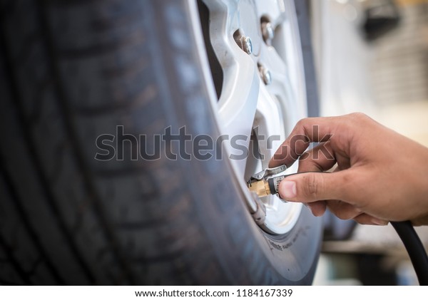 Car Tire\
Pressure Check in the Auto Service\
Garage.