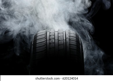 Car Tire And Smoke On Black Background