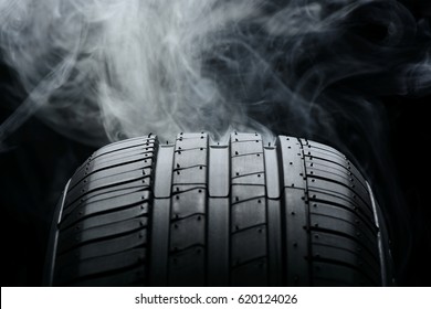 Car Tire And Smoke On Black Background