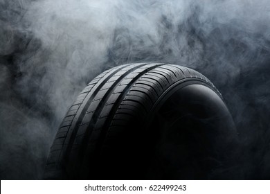 Car Tire And Smoke On Black Background