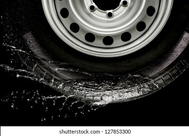 Car Tire Splashing In Water, Tire With Water.