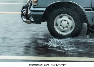 Car Tire Splashing In Water,tire On The Water,Dangerous Rain,water Spray From The Wheels,blur.