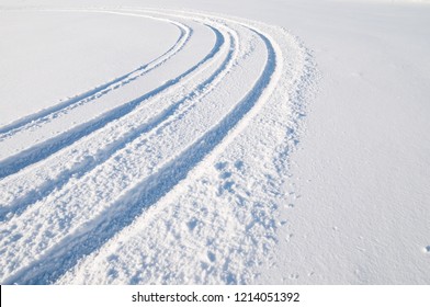 Car Tire Tracks In Fresh Snow.