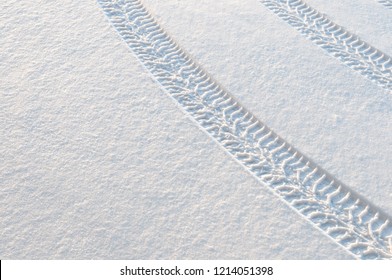 Car Tire Tracks In Fresh Snow.