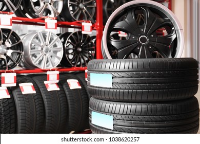 Car tires and alloy wheels in automobile store